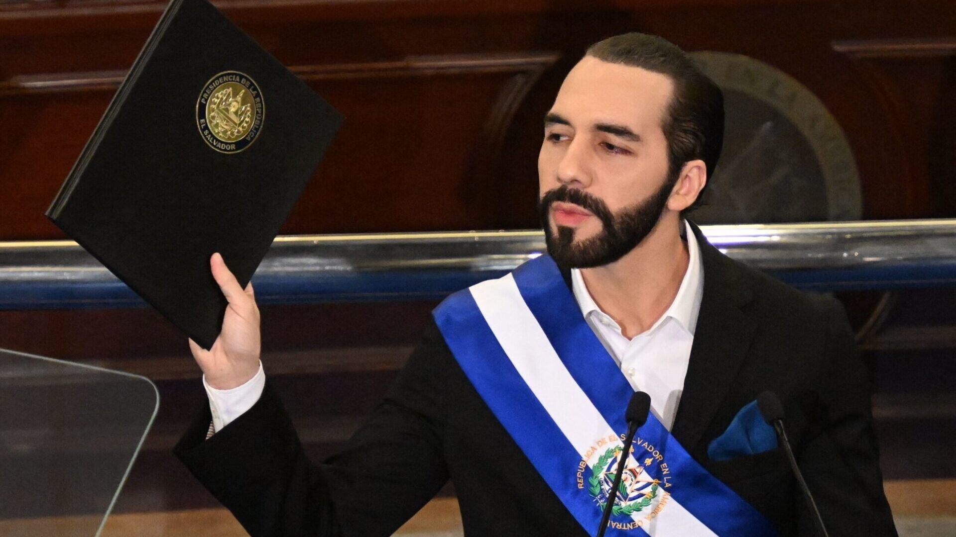 (FILES) Salvadoran President Nayib Bukele delivers his annual address to the nation marking his fourth year in office at the San Salvador Legislative Assembly on June 1, 2023. El Salvador's Nuevas Ideas (NI) party announced on June 26, 2023, that its leader, Nayib Bukele, has registered as a pre-candidate for the Presidency of the Republic to seek re-election in the 2024 elections, an option enabled by the justice system despite the fact that in theory the Constitution prohibits it. (Photo by MARVIN RECINOS / AFP)